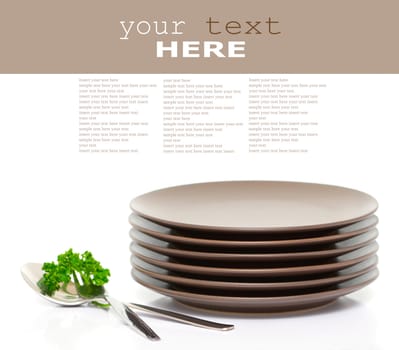 Stack of brown round plates with fork, spoon and parsley (with sample text)
