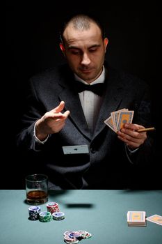 Portrait of a poker player over black background 