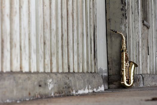 old grungy saxophone with old retro background