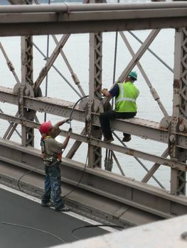 two workers on Brooklyn Bridge, new york city