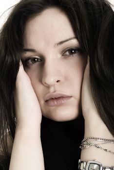 Portrait of a young brunette with unhappy look