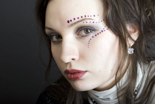 Portrait of a young beautiful brunette with eastern make-up