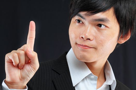 young business man in a suit pointing with his finger