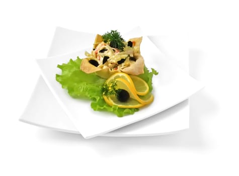Salad with crab meat, egg, olives, mayonnaise in a basket isolated