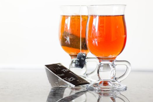 Teaglasses with tea on kitchen dresser by natural light - horizontal and shallow dept of field