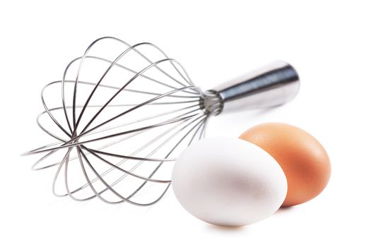 Two eggs and whisk isolated over white background