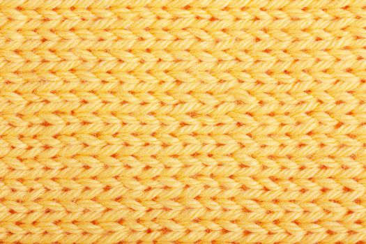 Macro view of yellow knitting. Horizontal orientation