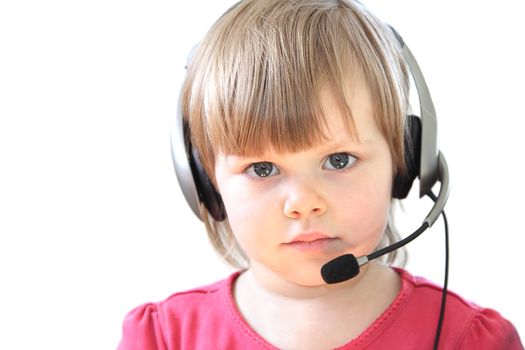 Cute toddler girl with a headset over white background