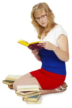 Young woman reading a book sitting on the floor