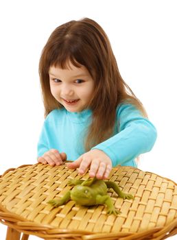 Girl cautiously stroking a toy lizard isolated on white background