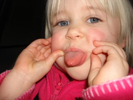 little girl making face