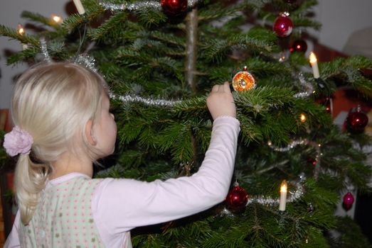 girl decorating the Christmas tree