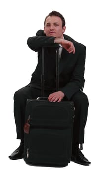 Tired and bored businessman with his suitcase,isolated against a white background.