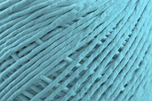 Close up on the fibres of a ball of string with pale blue light effect filter