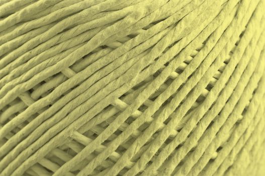 Close up on the fibres of a ball of string with light yellow light effect filter