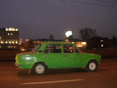 green car running on the road