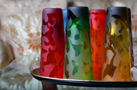 A set of beautiful colorful glasses on a table.