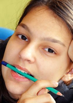 caucasian teenage girl portrait closeup biting pencil