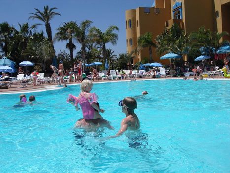 children swimming in the pool