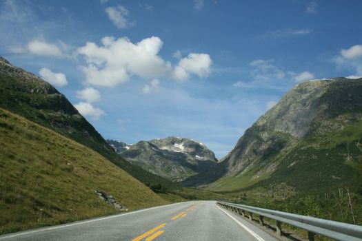 a road throw the beautiful norwegian mountains