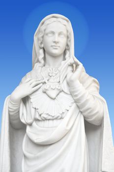 beatiful white statue of Virgin Mary on blue background