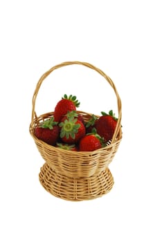 Fresh strawberries in small interwoven straw basket isolated on white background