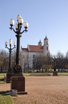 Antique lamps in Lukiskes Square in Vilnius, and the church in the distance.