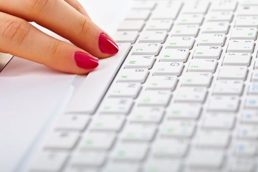 Ladies fingers on a white keyboard of laptop