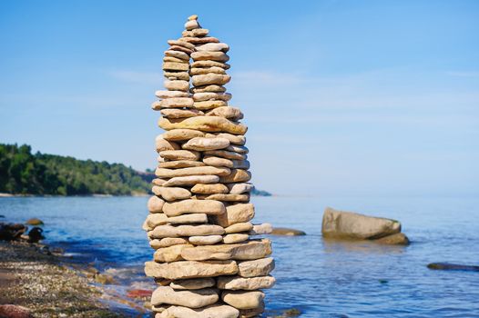 Pile of pebble as the tower on the sea coast