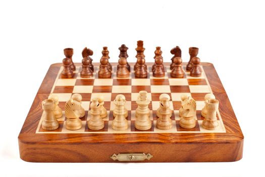Wooden chess on chessboard ready to play