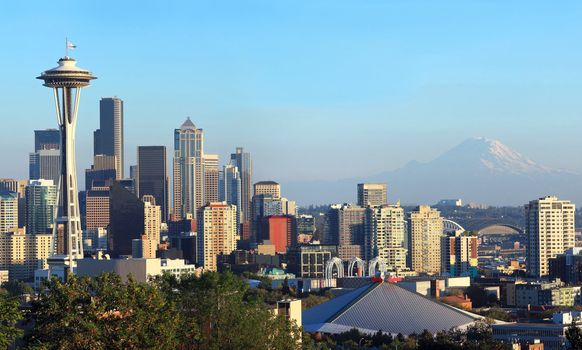 A panoramic view of the city of Seattle skyline and Mt. Rainier at sunset.