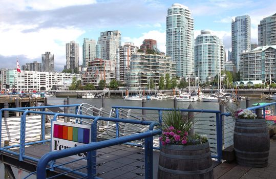 A ferry terminal in Granville island in Vancouver BC., Canada overlooking the skyline across False creek.