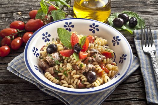 Italian Fusilli pasta with swordfish,olive and raw tomato