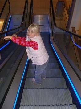 girl standing on the escalator