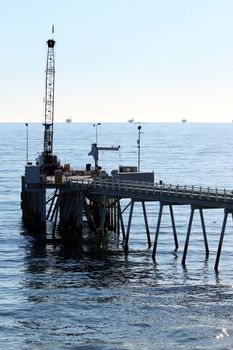 Carpinteria Pier with oil rigs at the horizon line