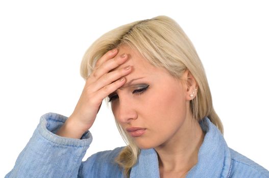 The blonde in a dressing gown with a headache it is isolated on a white background.
