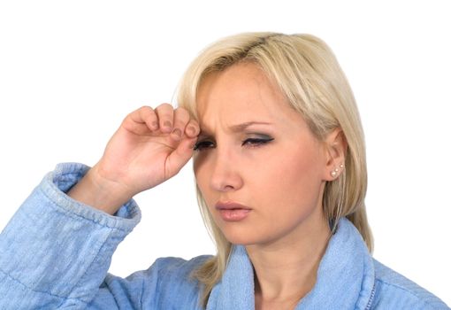 The blonde in a dressing gown with a headache it is isolated on a white background.