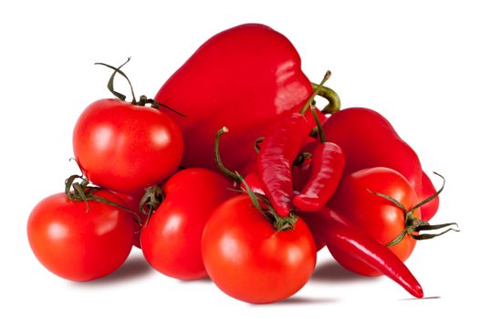 Peppers, tomatoes, lie on the white table. Vegetables on a white background.