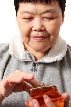senior chinese woman taking money from bag