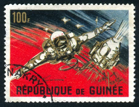 GUINEA - CIRCA 1965:   stamp printed by Guinea,  shows American and Russian achievements in space, circa 1965.