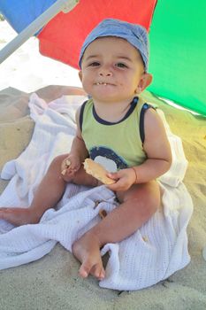 Little boy eating a biscuit