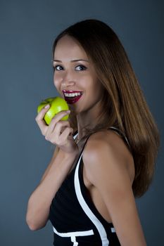 Attractive model with an apple in a hand