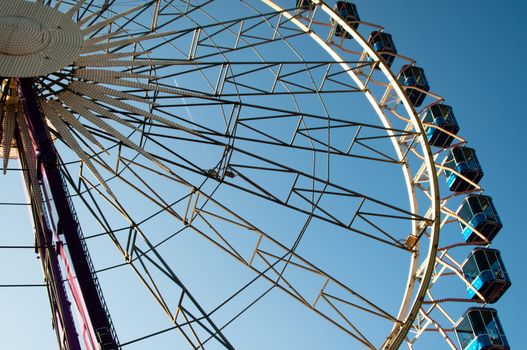 ferris wheel at amusement park against great blue sky