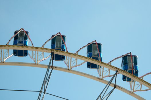 ferris wheel at amusement park against great blue sky