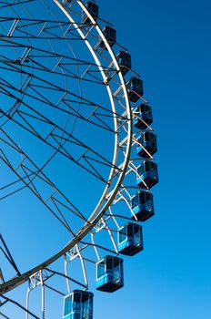 ferris wheel at amusement park against great blue sky