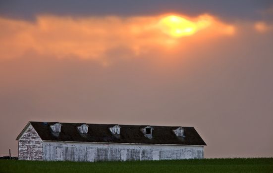 Long garage under cloudy sky