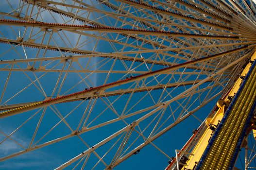 ferris wheel at amusement park against great blue sky