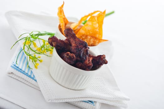 chicken legs with chips on a white background