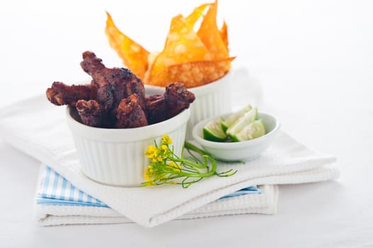 chicken legs with chips on a white background