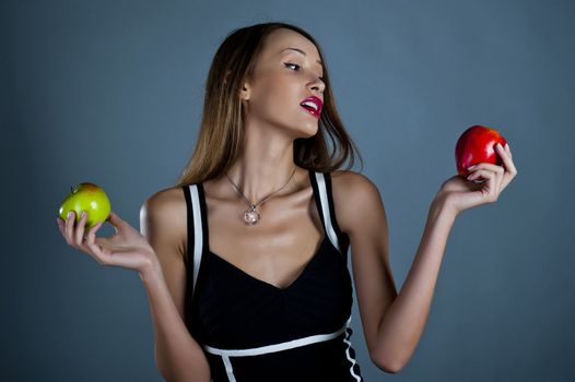 Attractive model with apples in hands